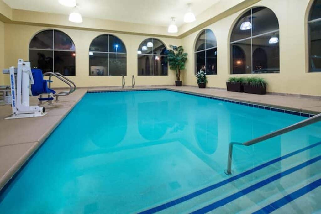 Hotel indoor pool with mobility lift on the left side.