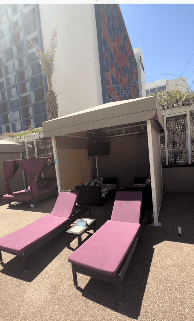 Harrah's Cabana with 2 loungers with purple cushions in front of the cabana.