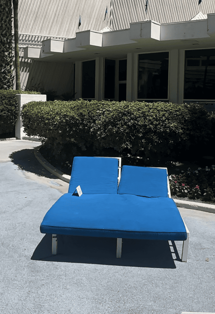 Daybed with blue mattress and cushions.
