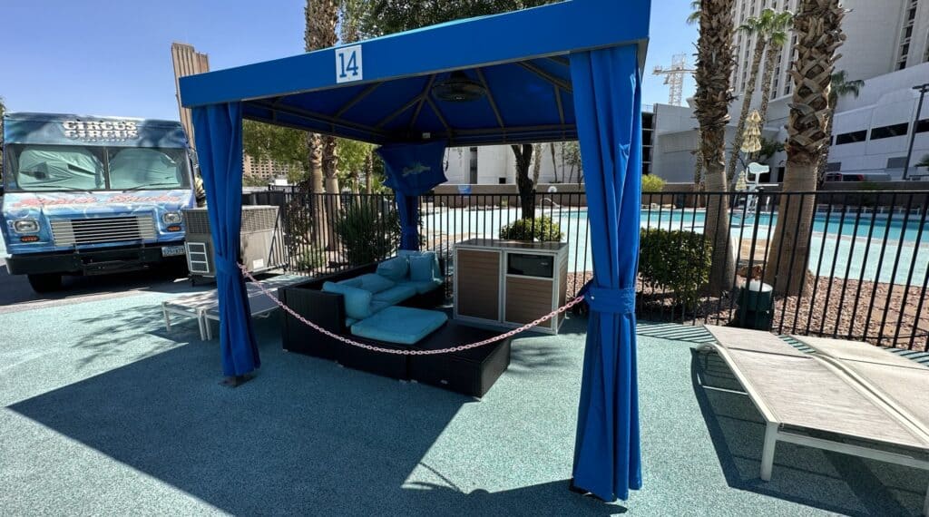Blue accented cabana at the Circus Circus Las Vegas pool deck. Seating and storage can be seen in the cabana