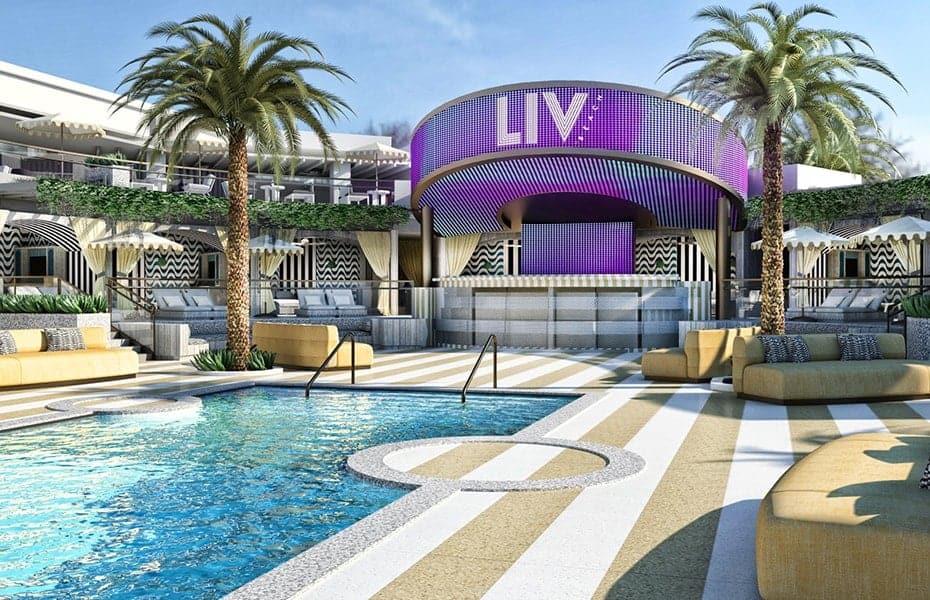 Las Vegas LIV Beach pool with large LIV letters ona large purple backdrop.