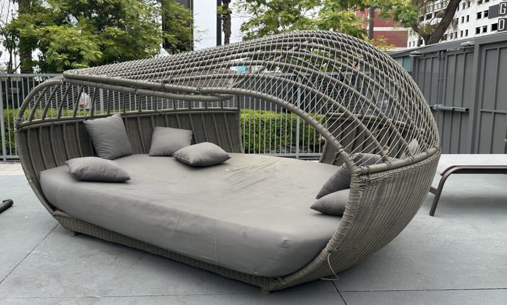 Oasis at Gold Spike funky looking daybed with multiple brown pillows on a large brown mattress.
