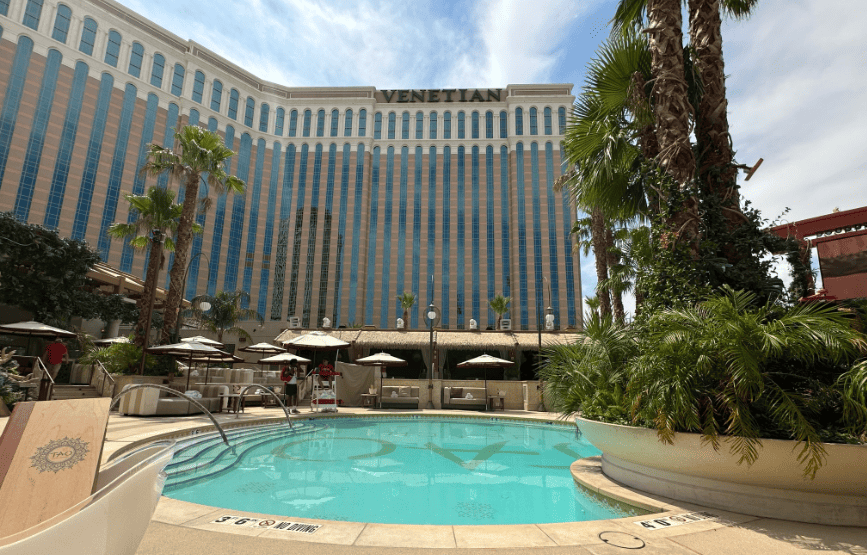 Tao Beach pool in the foreground with the Venetian Las Vegas tower in the background.