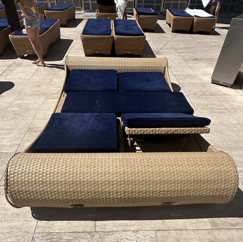 WEll padded blue loungers on the pool deck.