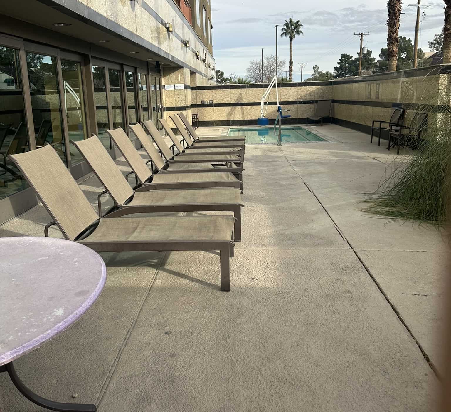 Loungers lined up in front of the outdoor hot tub.