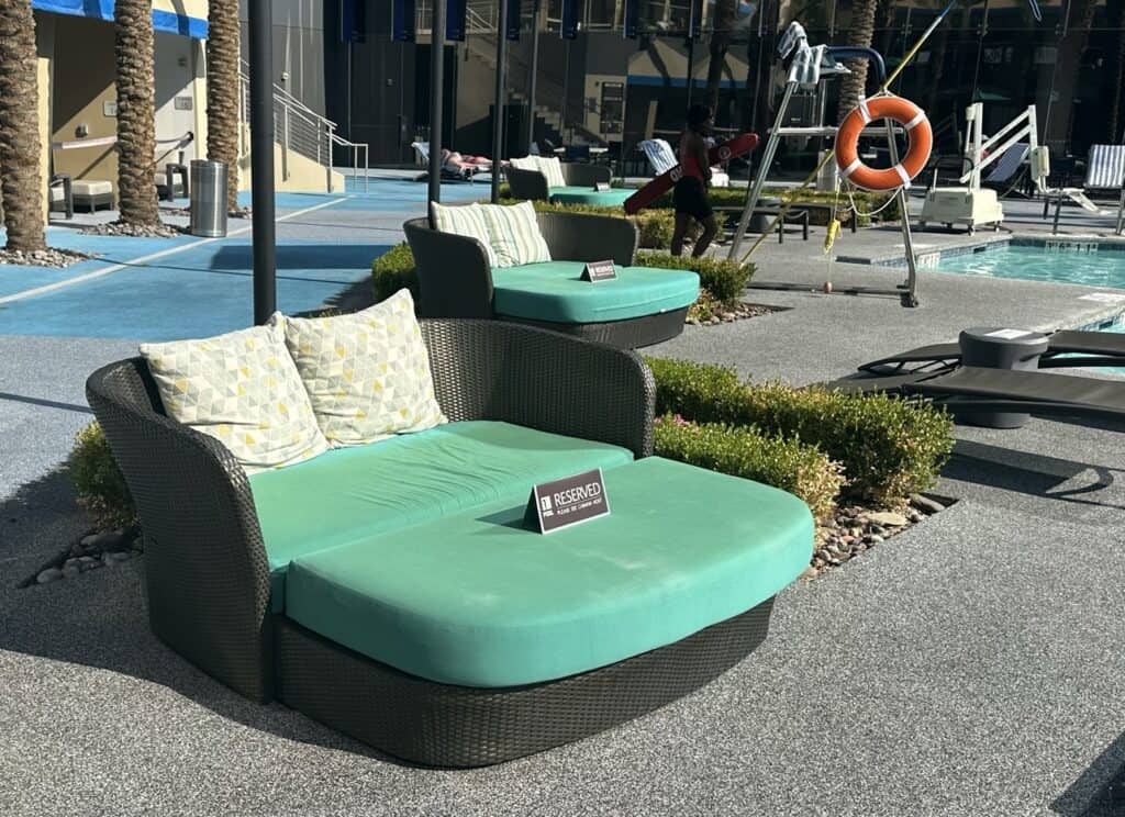 A row of daybeds along the pool deck.