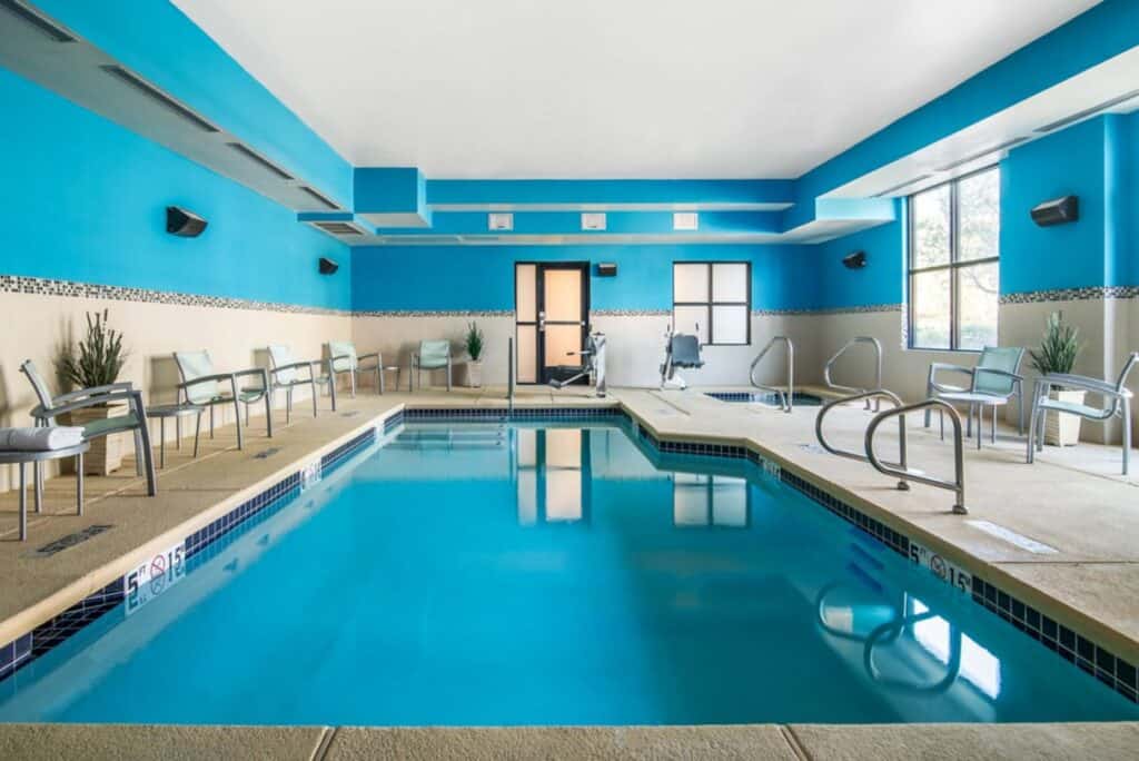 Hotel indoor pool with chairs on the pool deck