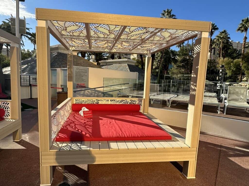 Red daybed with four post canopy.