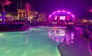 Purple lit stage at the end of the pool.
