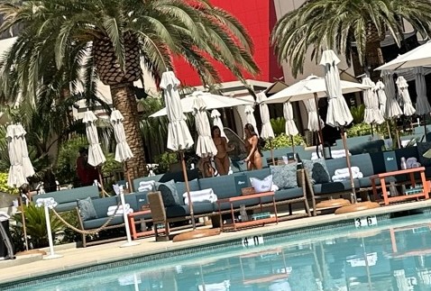 Poolside couches with servers in the background